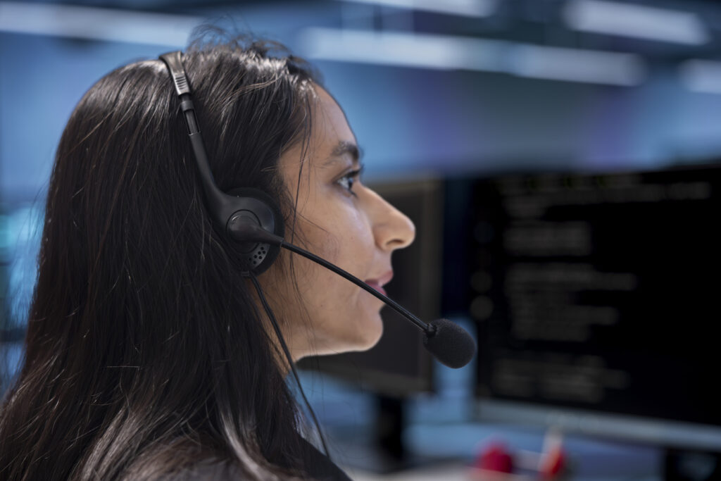 A customer service representative using AI-powered interactive voice response (IVR) systems to assist callers with automated and efficient communication