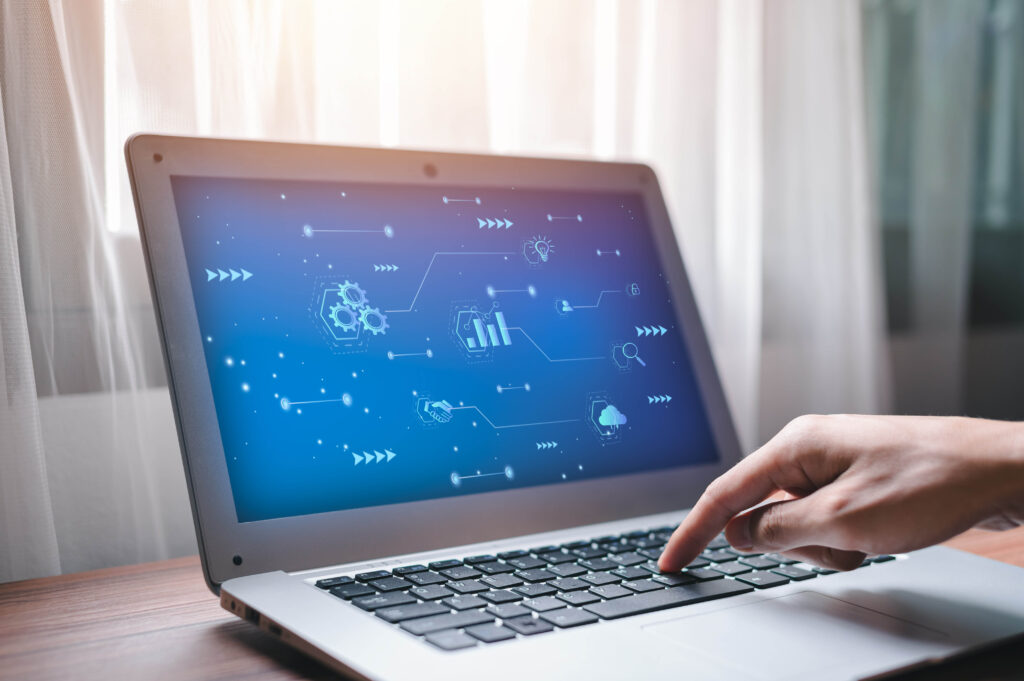 A laptop screen shows a digital dashboard comparing the capabilities of customer data platforms (CDPs) and marketing automation tools.