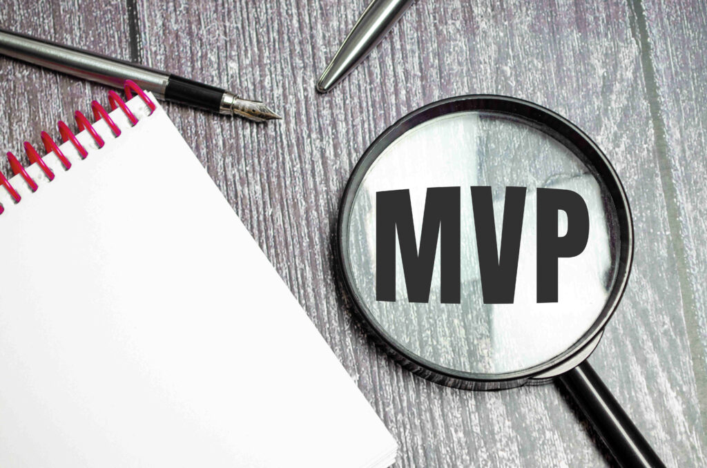 A magnifying glass focusing on the acronym MVP, representing the Minimum Viable Product in software development