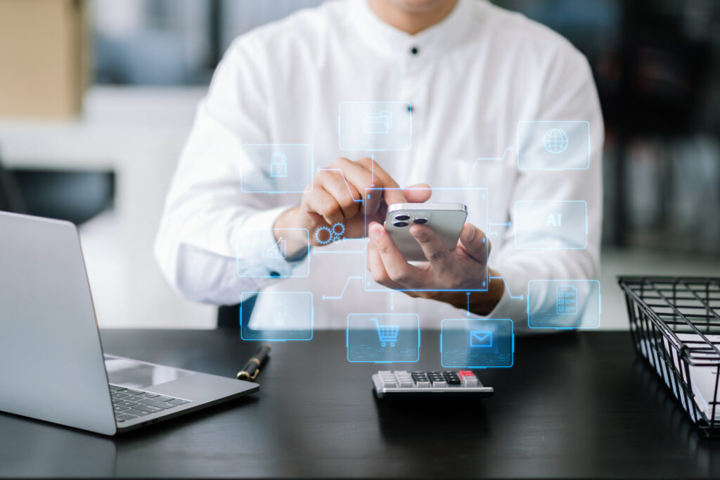 A person in a business setting interacts with a smartphone displaying a futuristic mobile app interface. Various business and technology icons float around, symbolizing advanced business mobile applications.