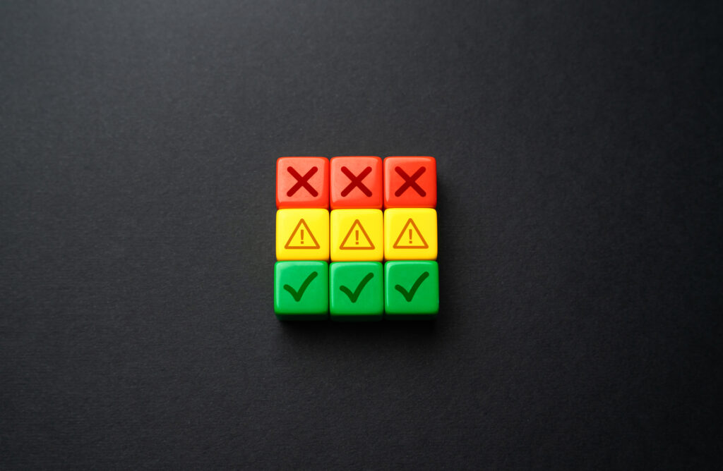 Image showing project deliverables status with three columns of colored blocks: red with X marks for incomplete, yellow with exclamation marks for pending, and green with check marks for completed.