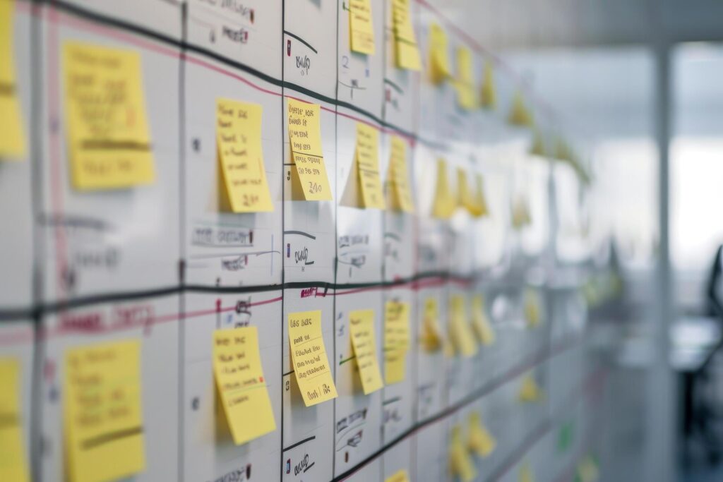 A project management board filled with sticky notes detailing various project deliverables, tasks, and deadlines.