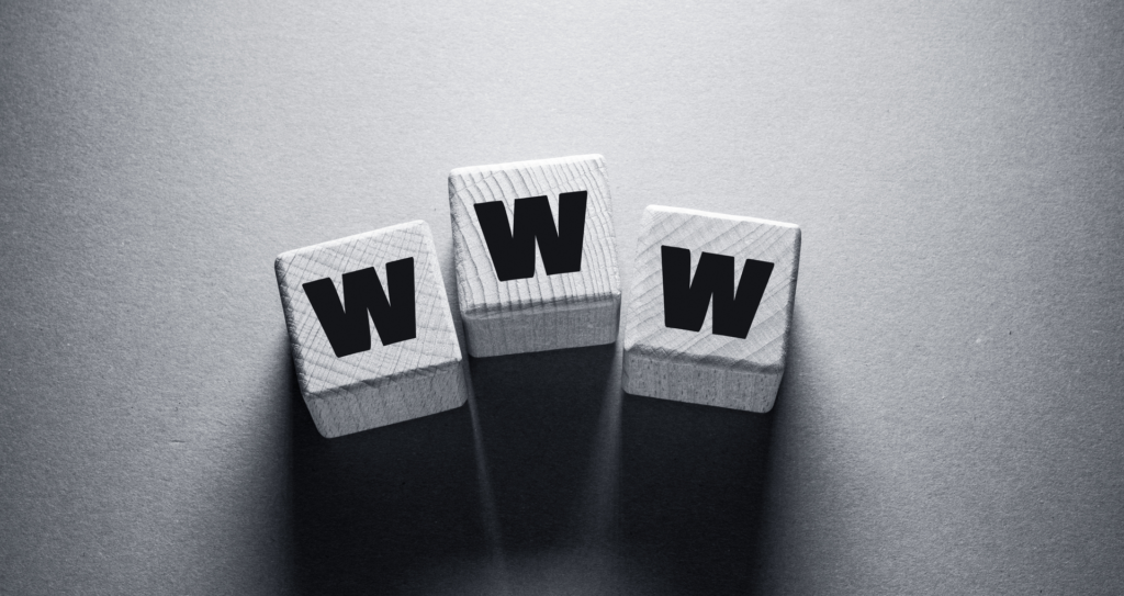 Three wooden blocks with the letter 'W' on each, symbolizing the World Wide Web, representing the importance of SaaS marketing websites in the digital landscape