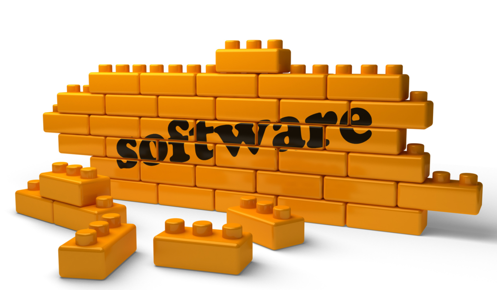 A wall of orange building blocks with the word 'software' written across them, representing a software stack. Several blocks are scattered in front of the wall.