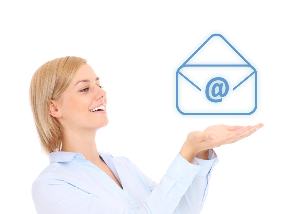 A woman smiling and holding her hands up as if presenting an email icon, symbolizing the ease and connectivity of email marketing campaigns. Perfect for illustrating the concept of digital outreach and communication