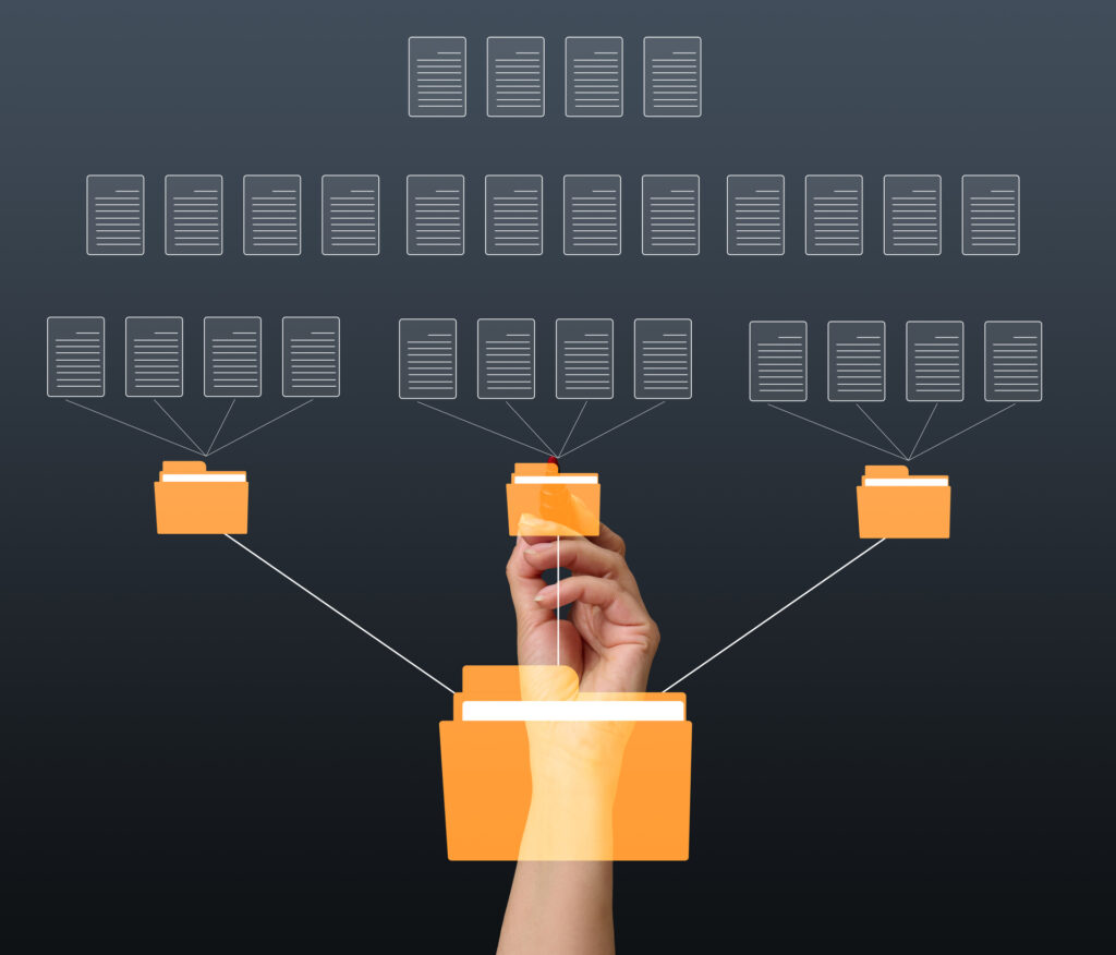 A hand organizing files and folders into a hierarchical structure, representing a data flow diagram.