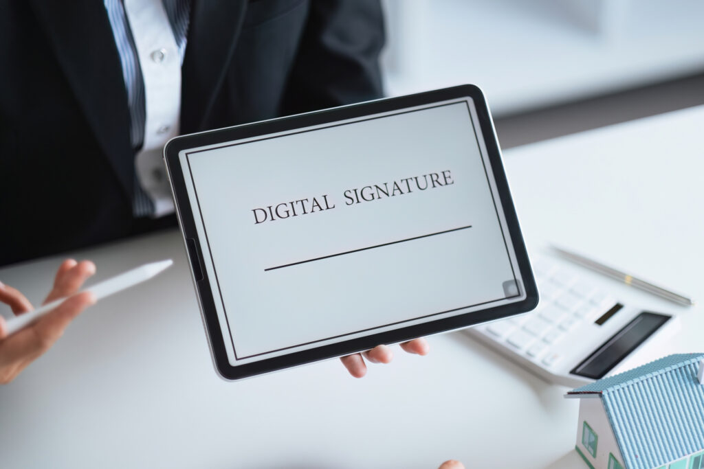 Close-up of a digital signature on a tablet, symbolizing the adoption of e-signature technology in real estate transactions for efficient and paperless processing