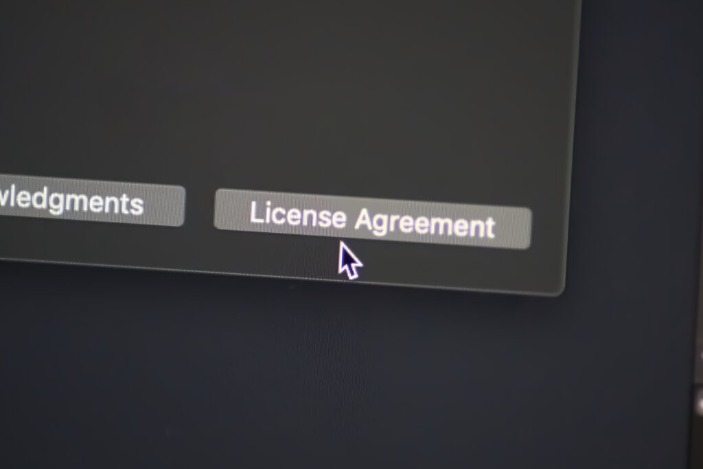 A computer screen showing a highlighted "License Agreement" button. This is a crucial step in the software licensing process.