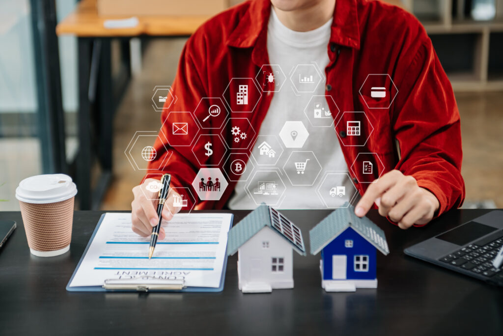 Real estate agent reviewing contract with digital icons representing smart technologies and financial tools, highlighting the integration of tech in property management and transactions