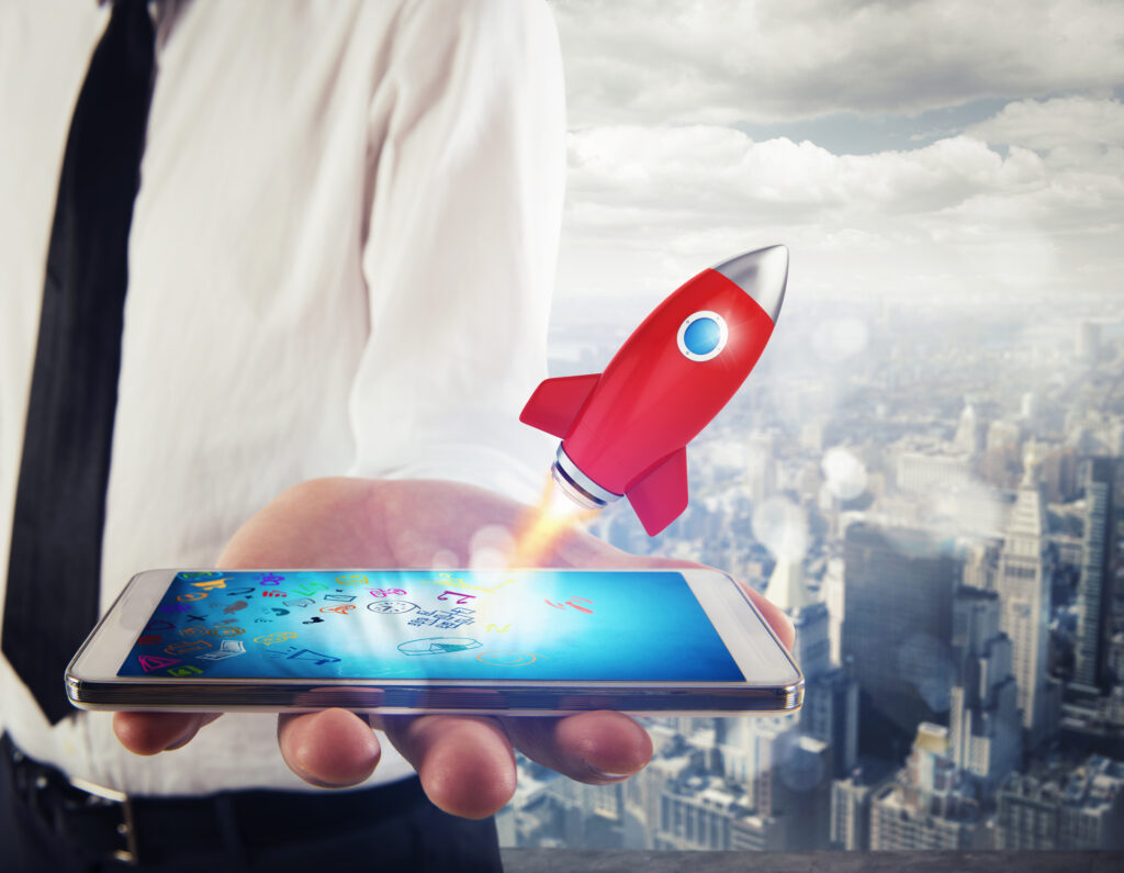 A hand holding a smartphone with a rocket launching from the screen, representing the excitement and momentum of a pre-launch campaign.