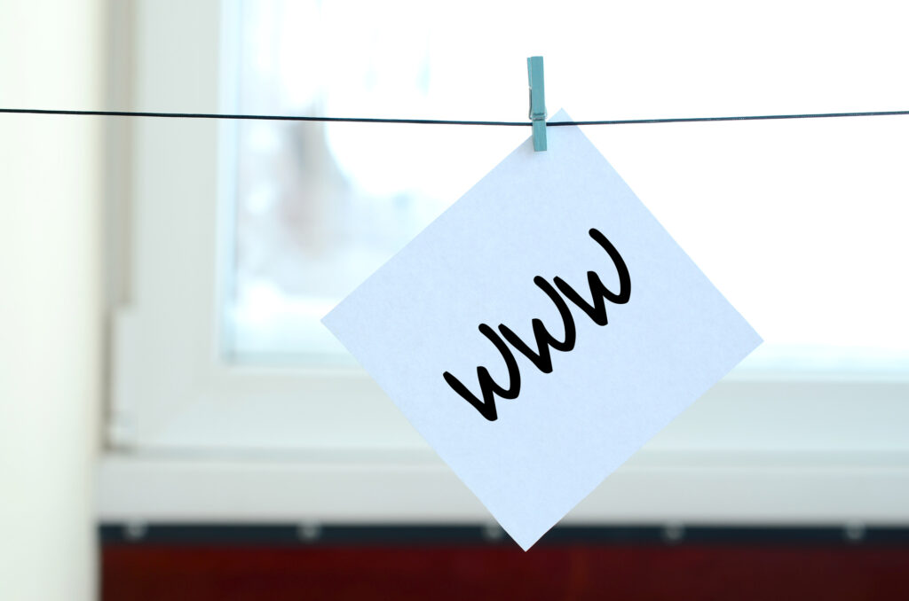 A square piece of paper with "www" written on it, hanging on a clothesline. This represents the World Wide Web, the foundation for both websites and web apps.