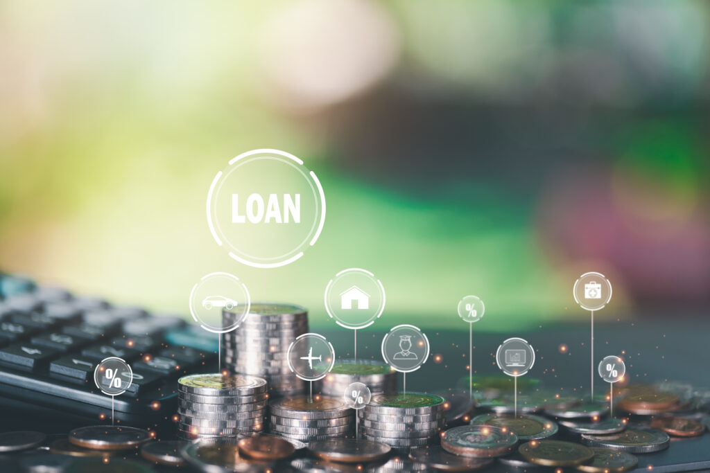 The word "LOAN" appears above a stack of coins, with icons representing interest rates, homeownership, and other financial concepts. This image visually represents the concept of borrowing money for various purposes.