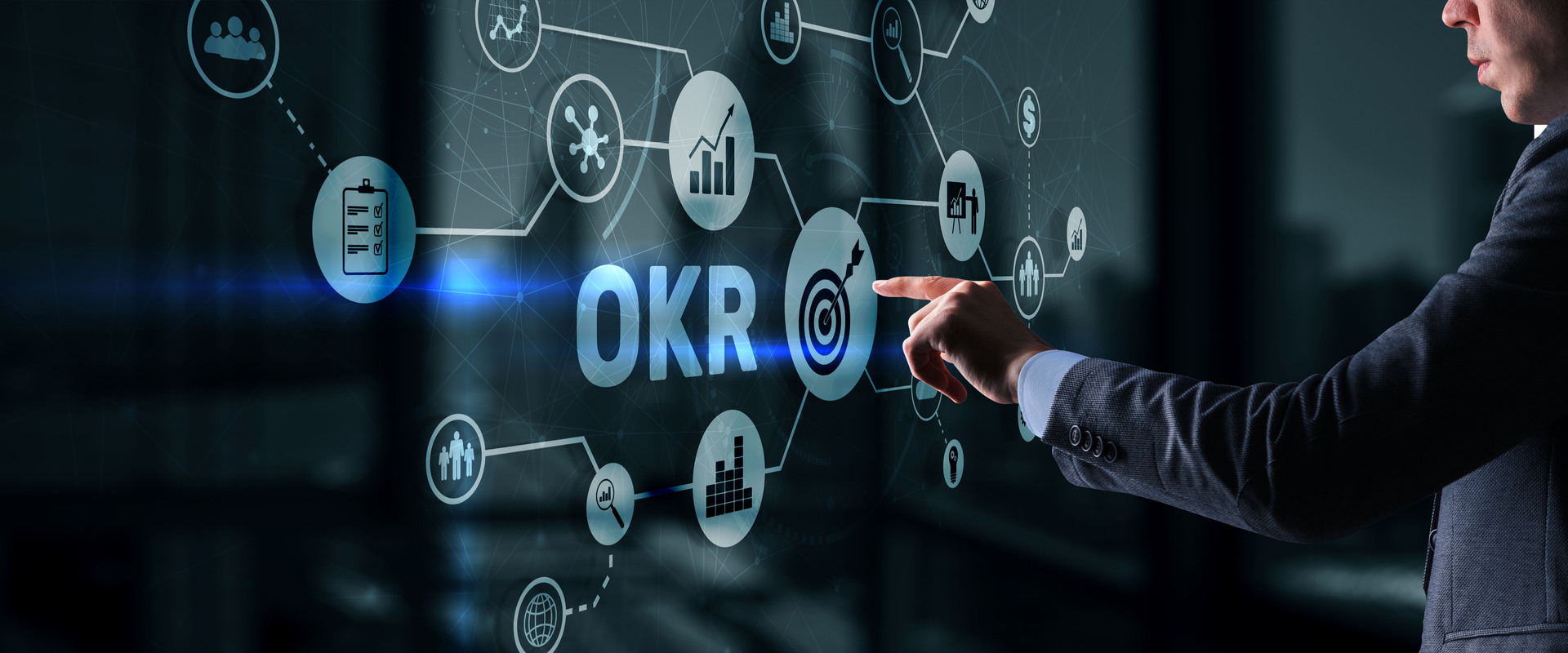 A professional in a suit interacts with a futuristic holographic display of various marketing icons and the acronym “OKR,” symbolizing the strategic alignment of objectives and key results in marketing