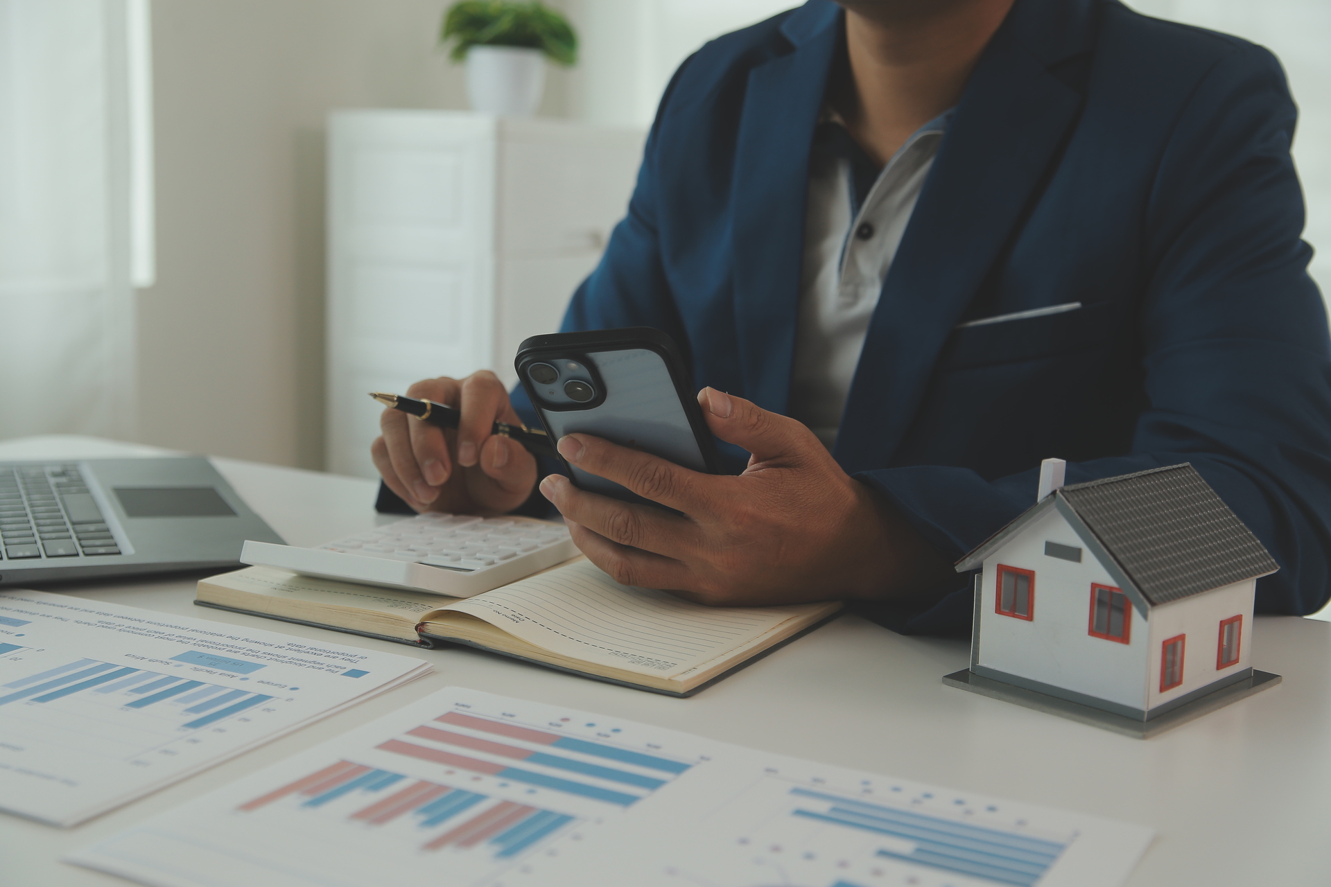 A real estate professional analyzing sales data and using customer engagement software to enhance client interactions, streamline processes, and boost property sales.