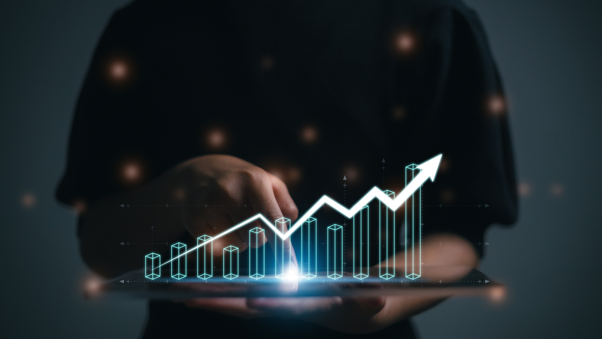 A person using a tablet to visualize upward growth trends with AlphaCalc Business Intelligence.